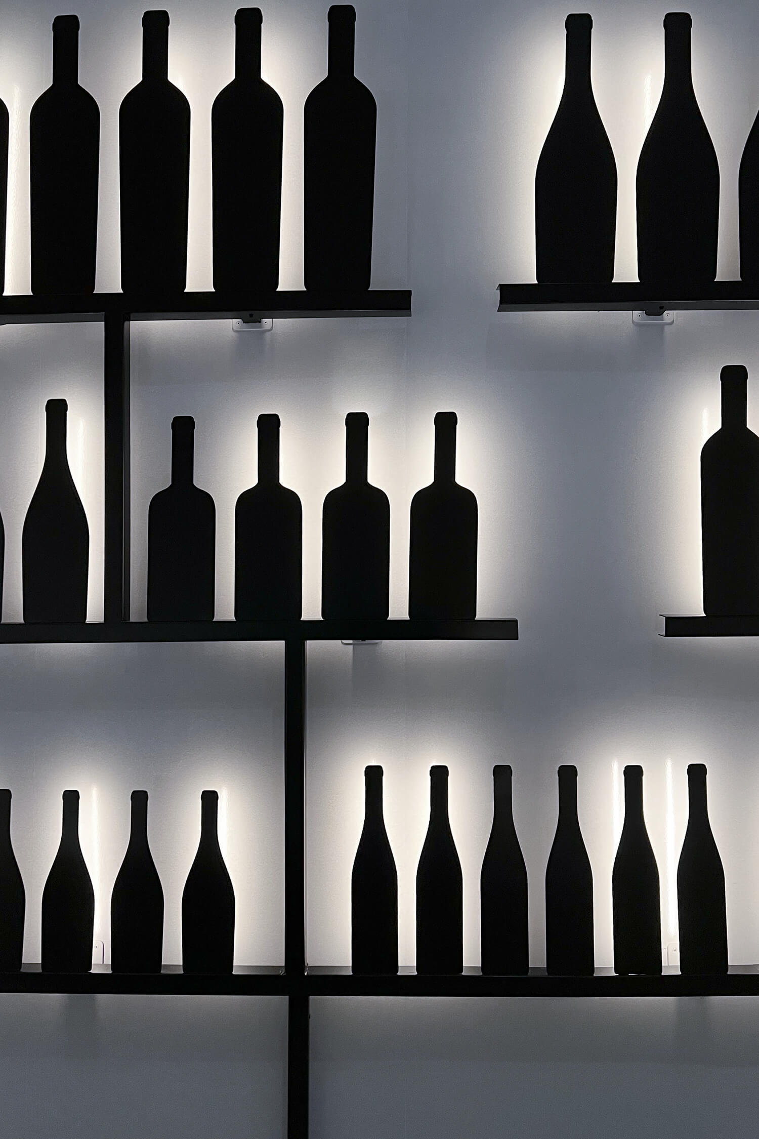 Zoom sur les bouteilles rétro éclairées de l'espace le vin et moi à la cité du vin de Bordeaux, design IchetKar